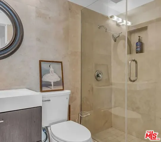 a bathroom with a toilet a sink and shower