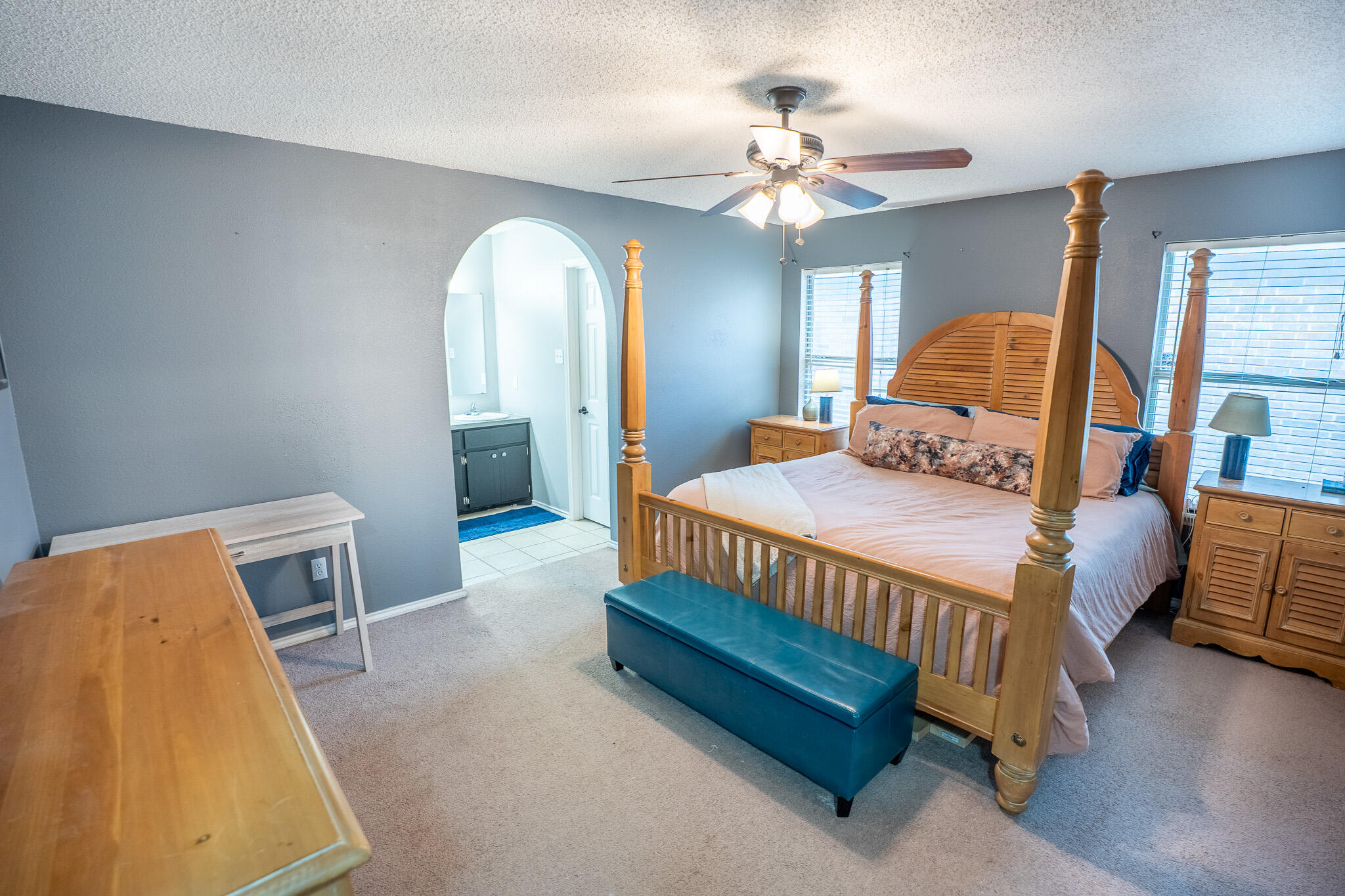 1609 78th Street Lubbock, TX 79423 - Photo 14 of 36 a bedroom with a bed and lamp