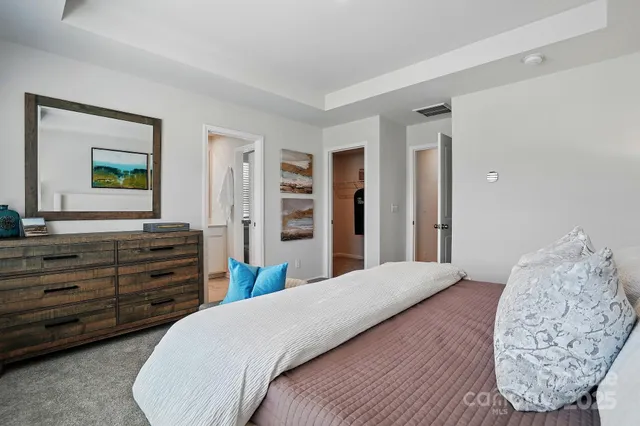 a bedroom with a bed and a dresser