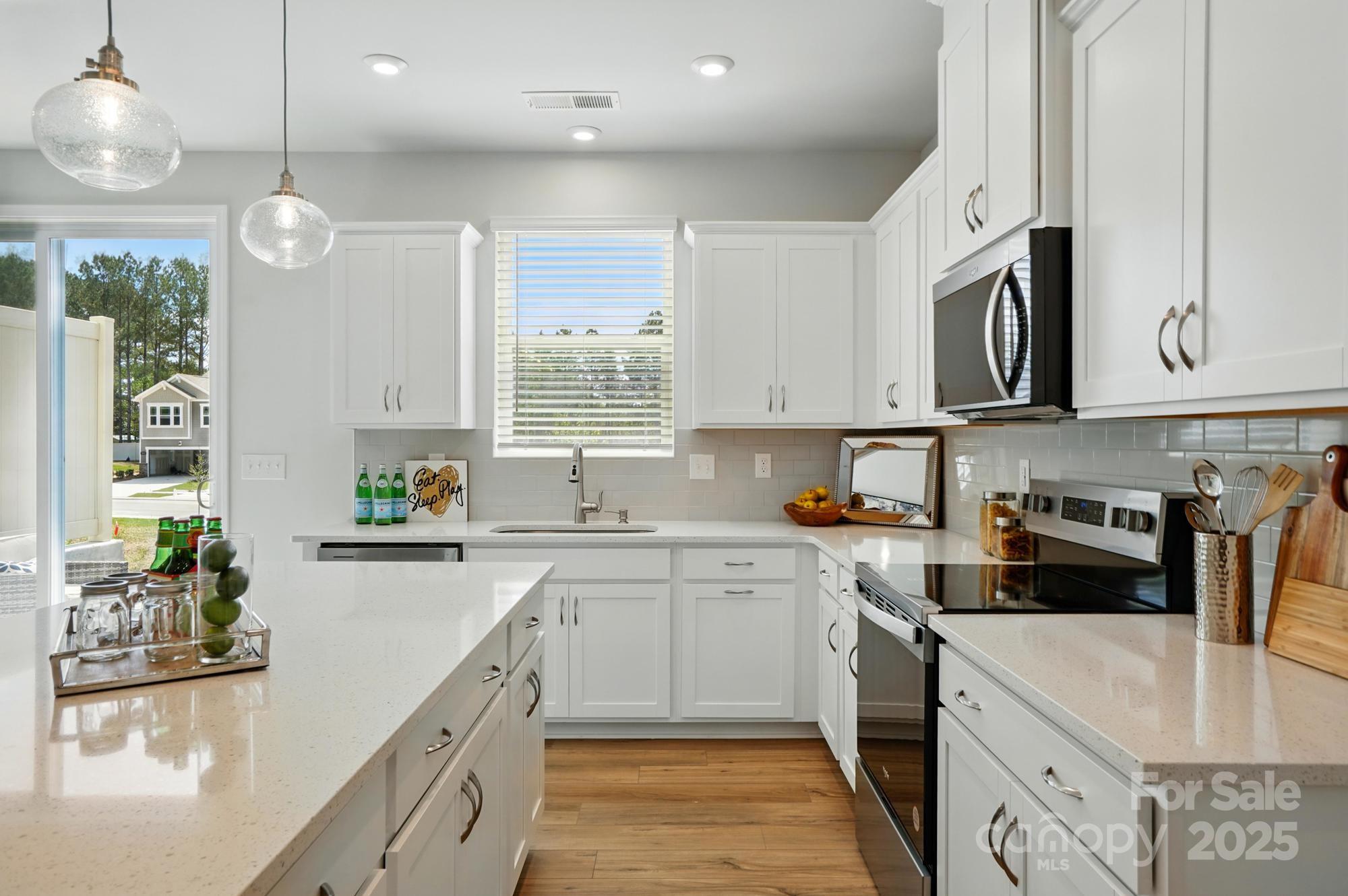 645 Cassidy Court Clover, SC 29710 - Photo 4 of 31 a kitchen with stainless steel appliances granite countertop a stove a sink and a microwave