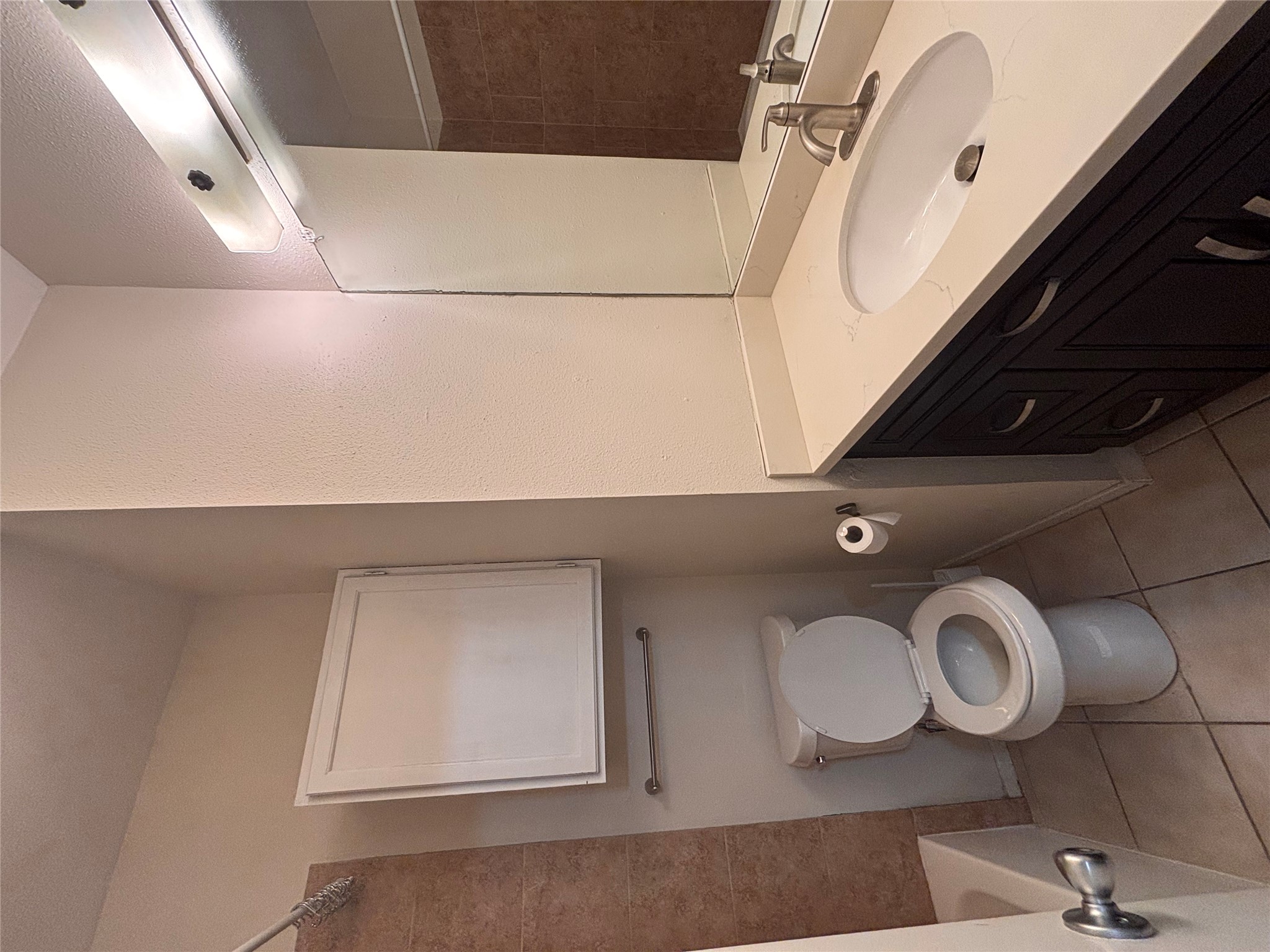 2801 Rio Grande Street, Unit 208 Austin, TX 78705 - Photo 13 of 25 A well-appointed bathroom offers a clean vanity with ample counter space and a practical shower area.