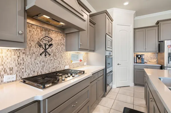 a kitchen with stainless steel appliances granite countertop a stove and a refrigerator