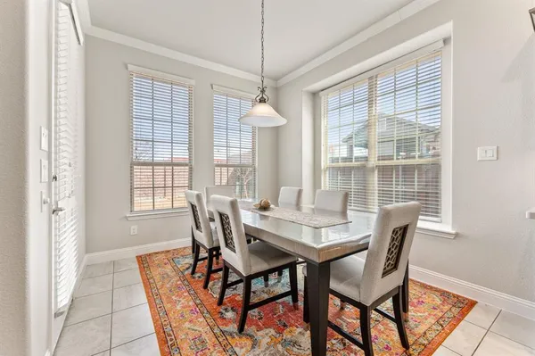 a dining room with furniture a chandelier and wooden floor