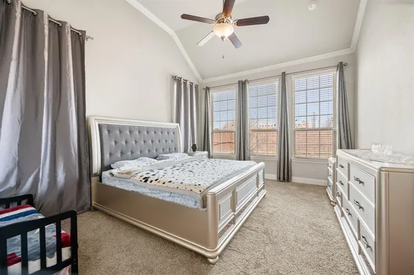 a spacious bedroom with a bed and a window