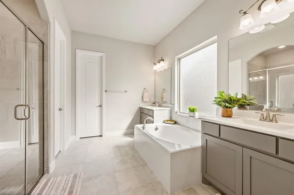 a bathroom with a sink a large mirror and a bathtub