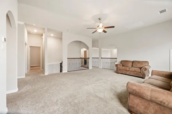 a view of a livingroom with furniture and a chandelier fan