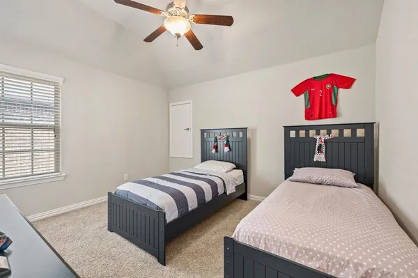 a bedroom with two beds and painted walls