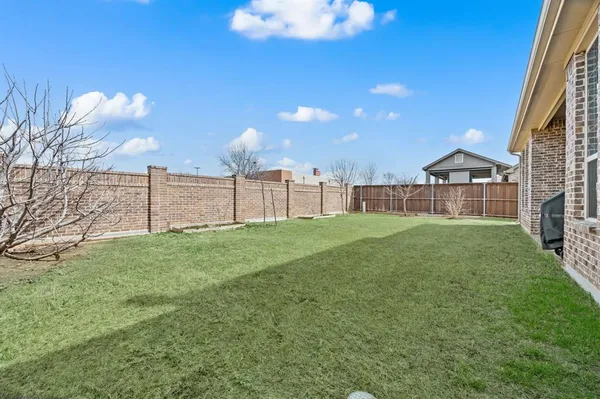 a view of a garden with a building in the background