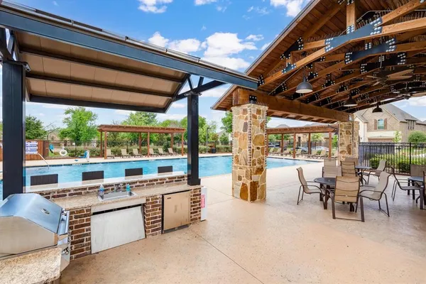 a living room with stainless steel appliances kitchen island furniture and a large window