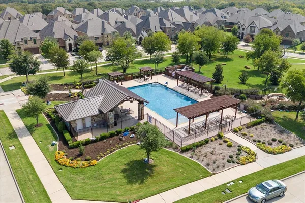 an aerial view of a house with garden space and lake view