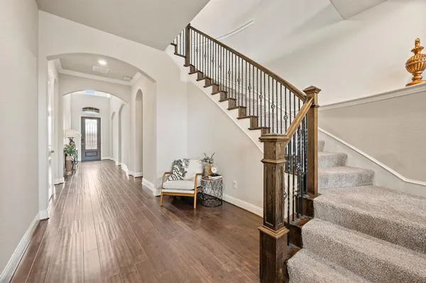 a view of entryway and hall with wooden floor