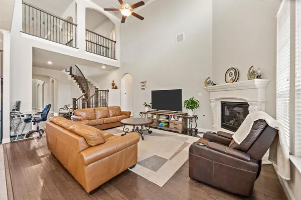 a living room with furniture a flat screen tv and a fireplace