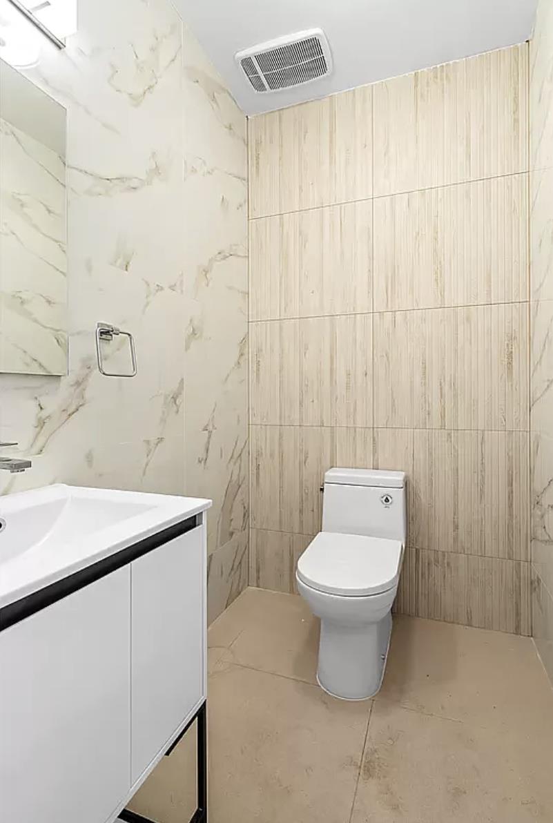 1105 Cortelyou Road, Unit PHA Brooklyn, NY 11218 - Photo 10 of 16 a bathroom with a sink a toilet and a mirror