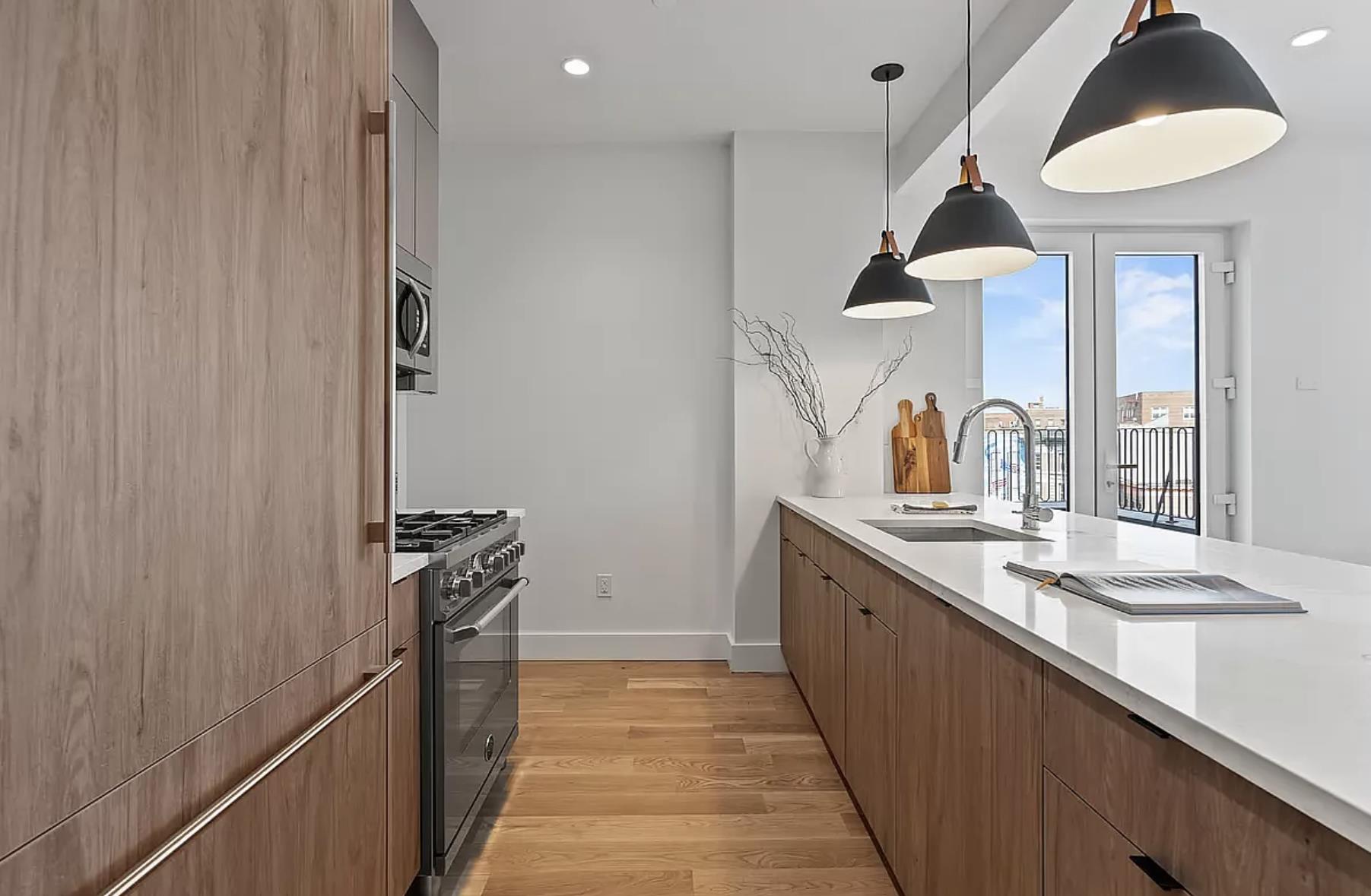 1105 Cortelyou Road, Unit PHA Brooklyn, NY 11218 - Photo 2 of 16 a kitchen with sink cabinets and stove