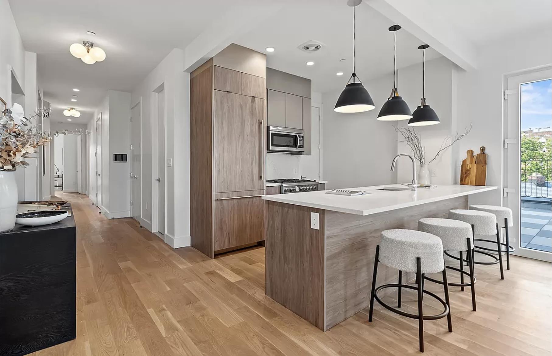1105 Cortelyou Road, Unit PHA Brooklyn, NY 11218 - Photo 4 of 16 a kitchen with kitchen island a counter top space a sink stainless steel appliances and cabinets