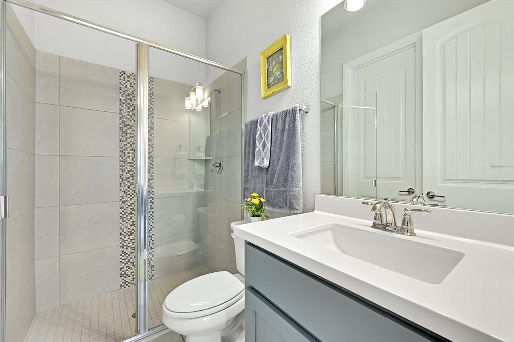629 Germander Road Leander, TX 78641 - Photo 17 of 32 A well-appointed bathroom features a glass-enclosed shower, contemporary vanity, and pristine fixtures.