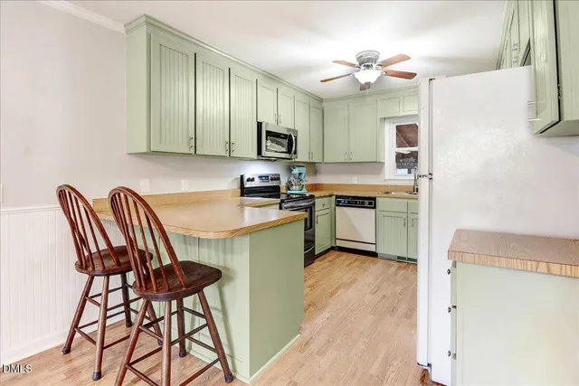a kitchen with furniture a sink and a window