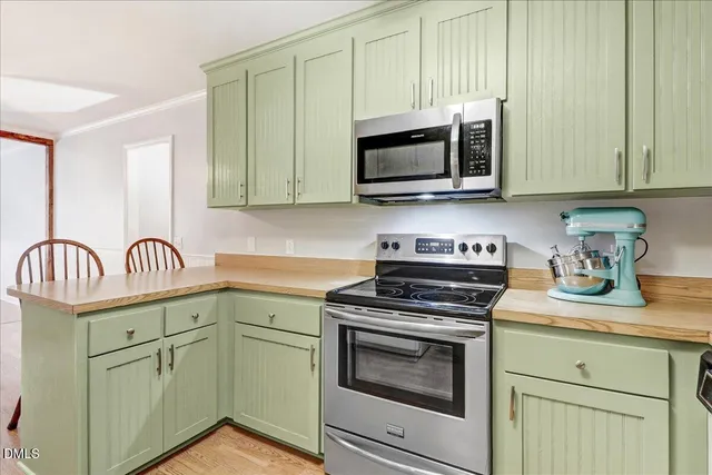 a kitchen with cabinets and a refrigerator