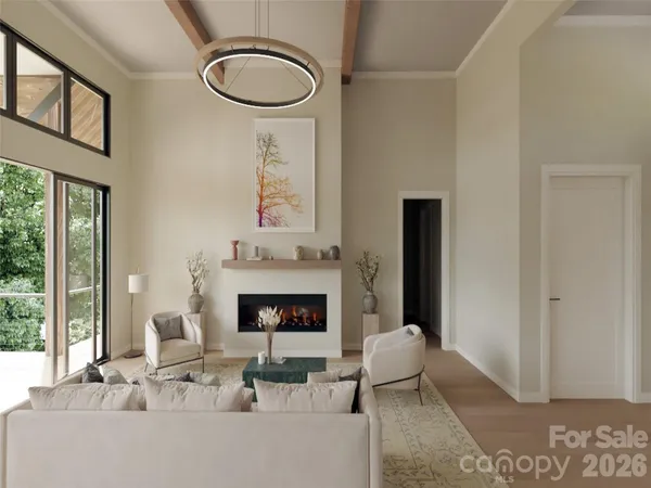 a living room with furniture a fireplace and a large window