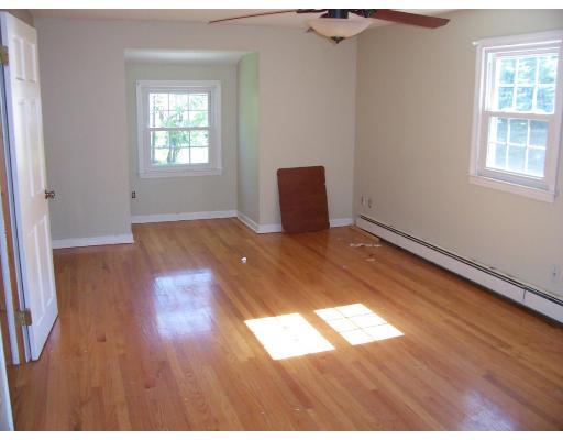 331 Glendale Road Wilbraham, MA 01095 - Photo 7 of 9 an empty room with wooden floor and windows
