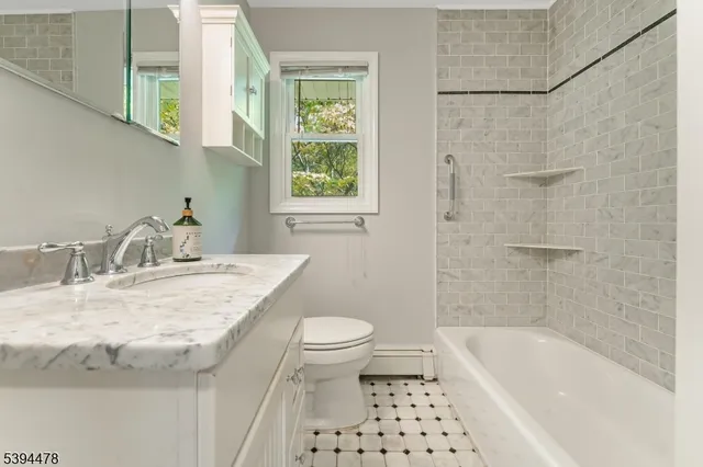 a bathroom with a sink a toilet and a bathtub
