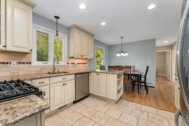 a kitchen with a sink a counter top space appliances and cabinets