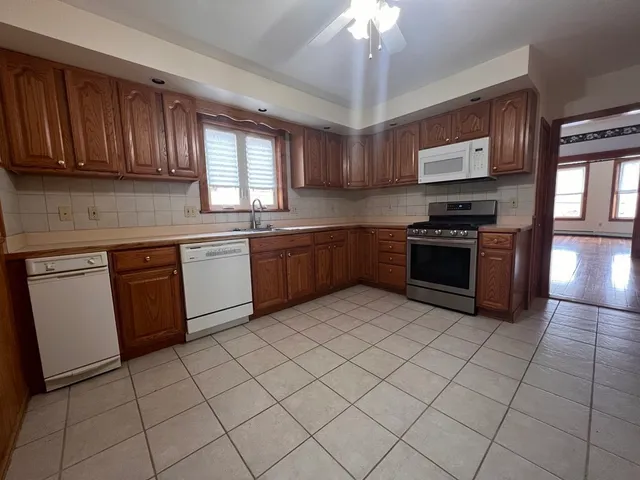 a kitchen with stainless steel appliances granite countertop a stove sink and cabinets