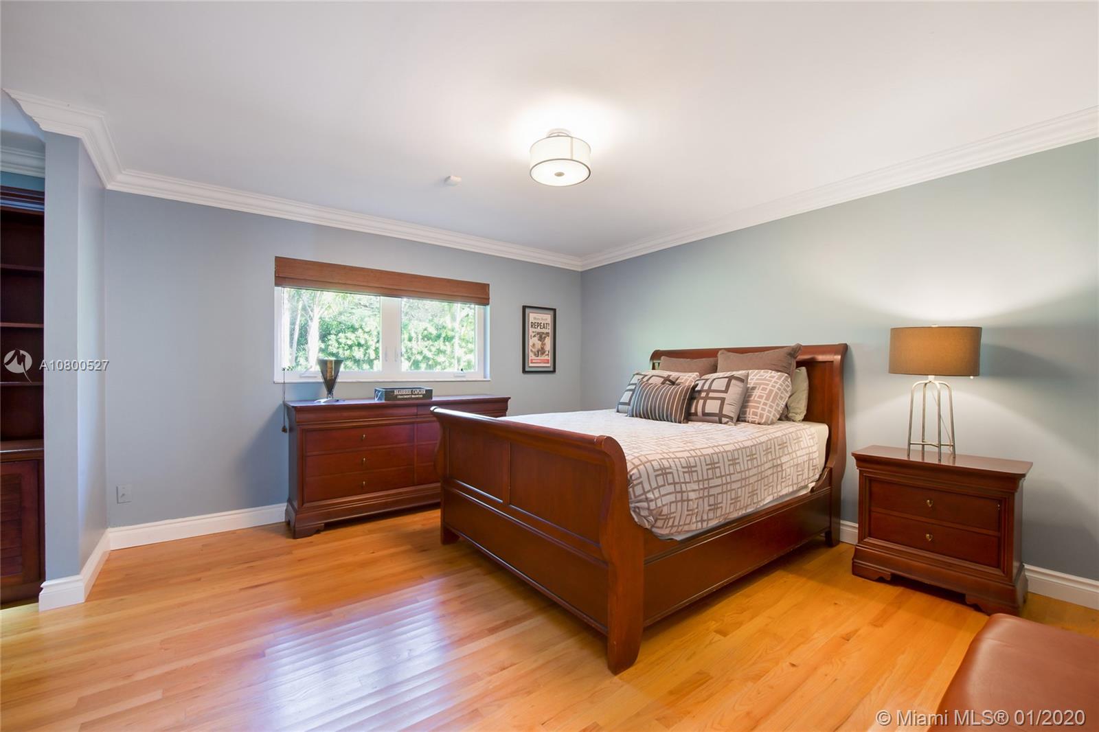 12440 Moss Ranch Road Pinecrest, FL 33156 - Photo 11 of 33 a bedroom with a bed and a window