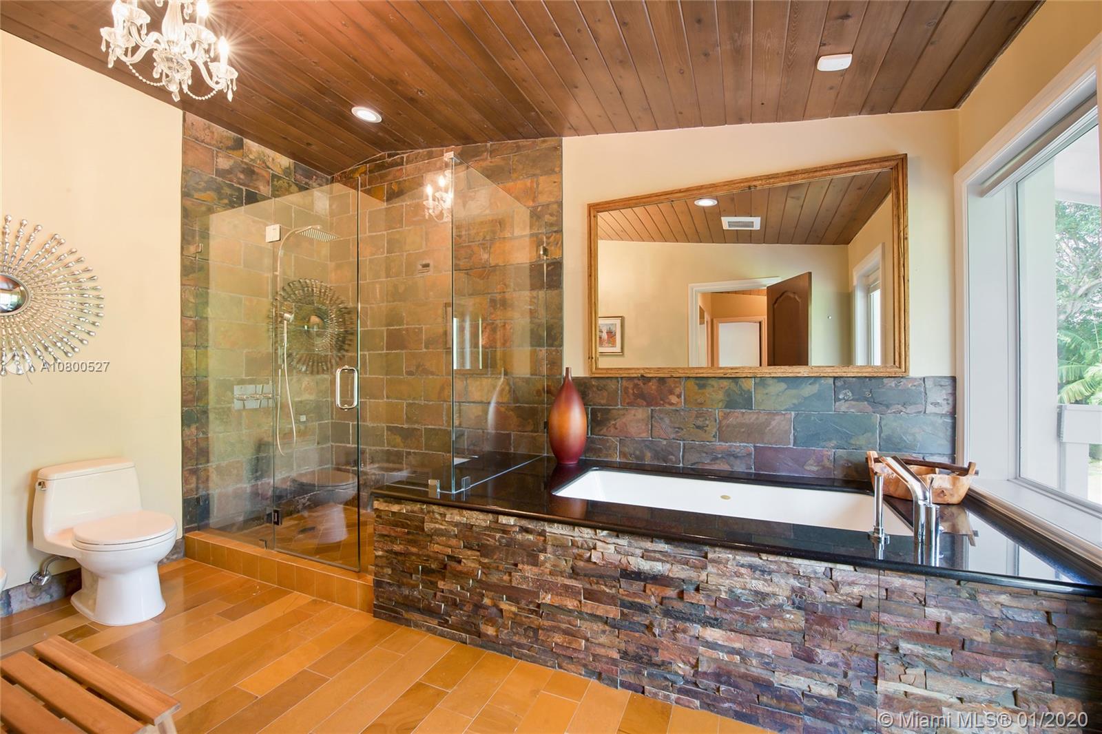 12440 Moss Ranch Road Pinecrest, FL 33156 - Photo 21 of 33 a bathroom with a bathtub and a toilet