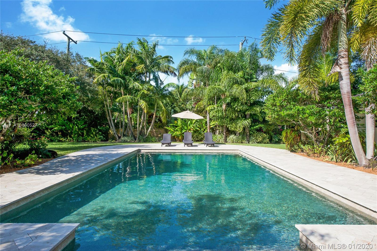 12440 Moss Ranch Road Pinecrest, FL 33156 - Photo 24 of 33 a view of a swimming pool with a yard