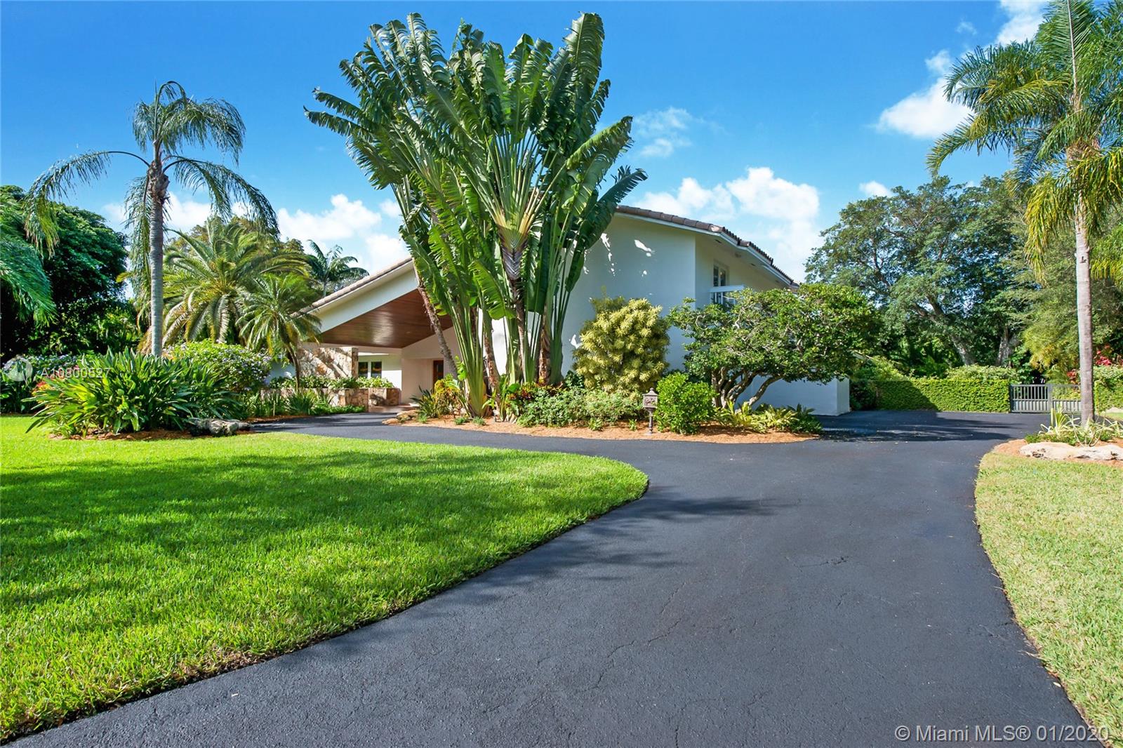 12440 Moss Ranch Road Pinecrest, FL 33156 - Photo 29 of 33 a view of a house with a street