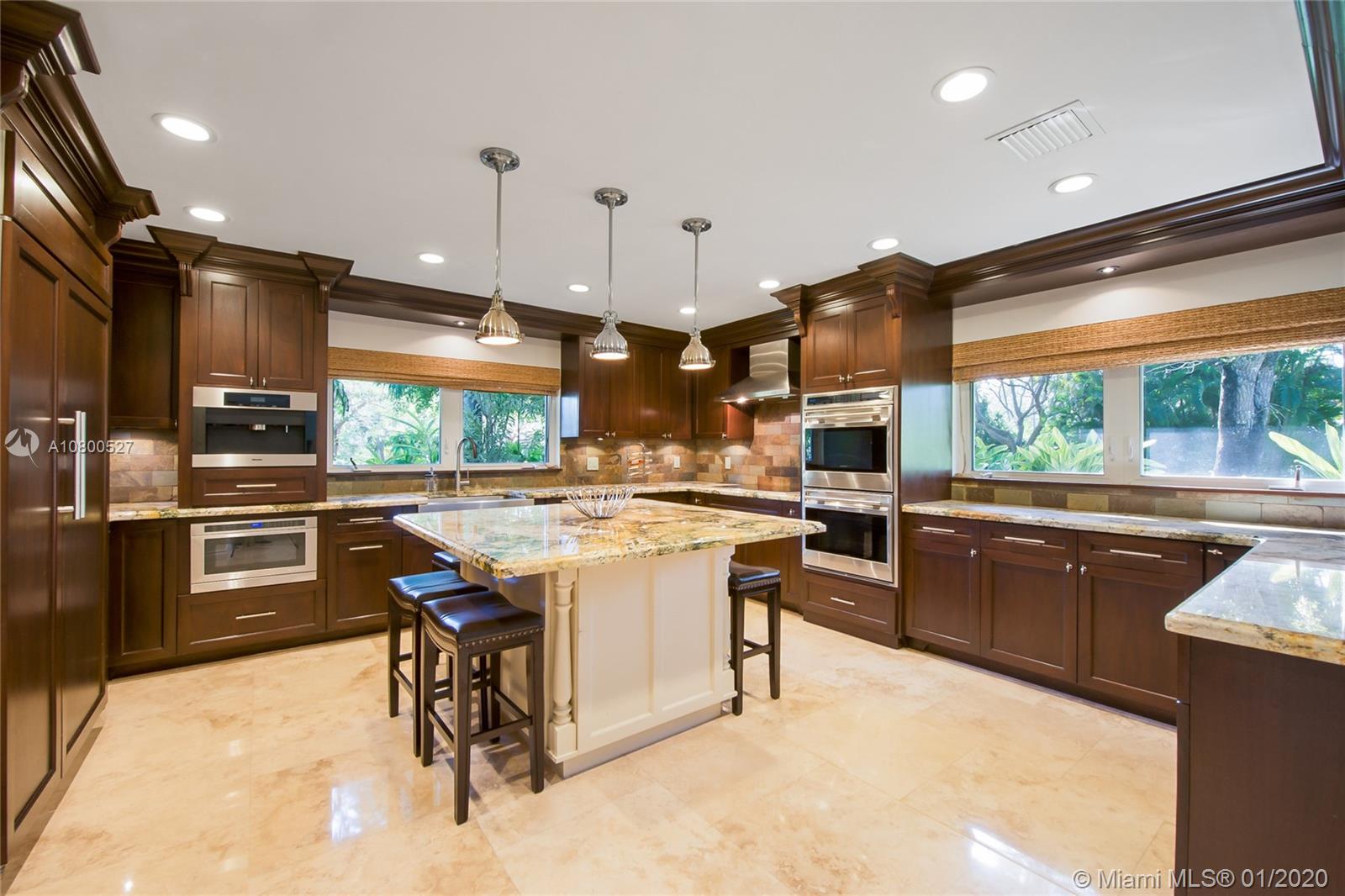 12440 Moss Ranch Road Pinecrest, FL 33156 - Photo 7 of 33 a kitchen with a sink a stove and chairs