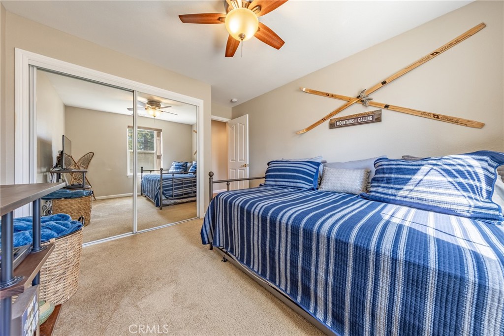 643 Purdy Road Chester, CA 96020 - Photo 16 of 29 a bedroom with bed and a chandelier