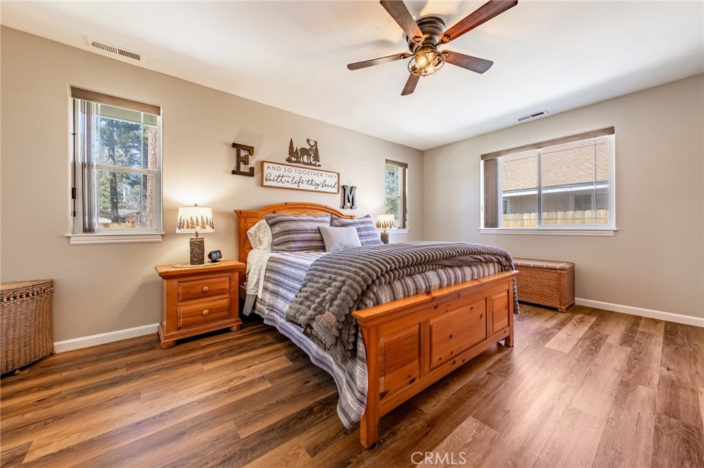 643 Purdy Road Chester, CA 96020 - Photo 18 of 29 a bedroom with a bed and wooden floor