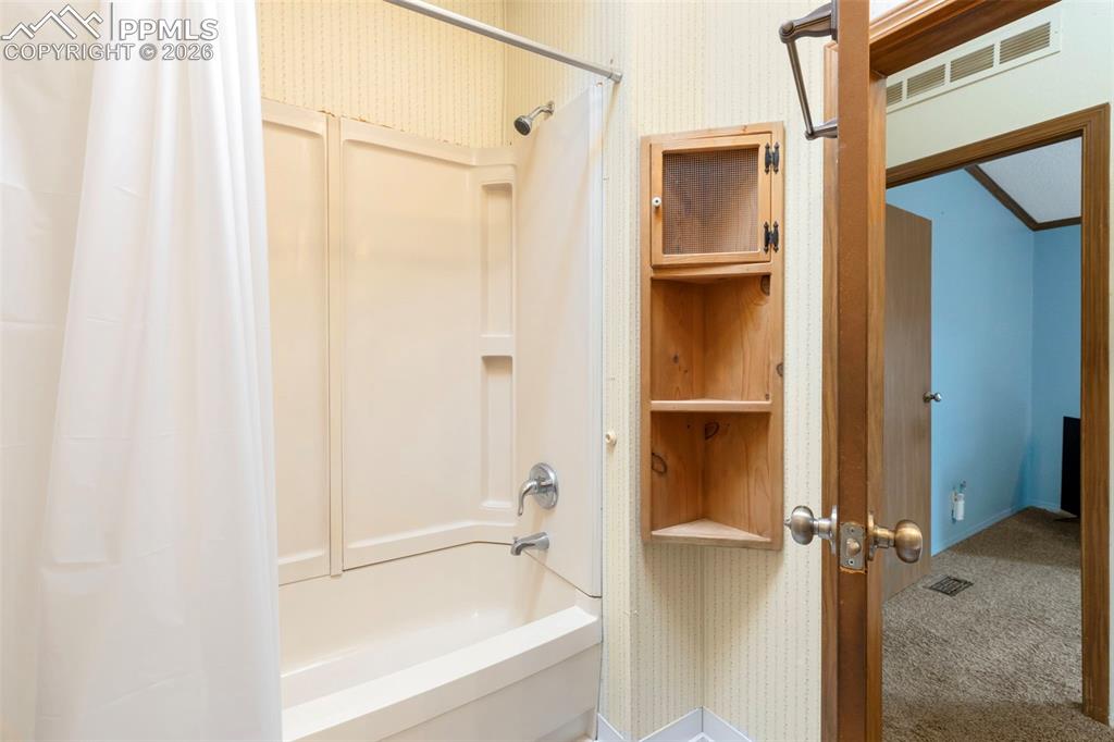 13335 Gymkhana Road Peyton, CO 80831 - Photo 31 of 38 Bathtub with integrated shower surround and chrome fixtures