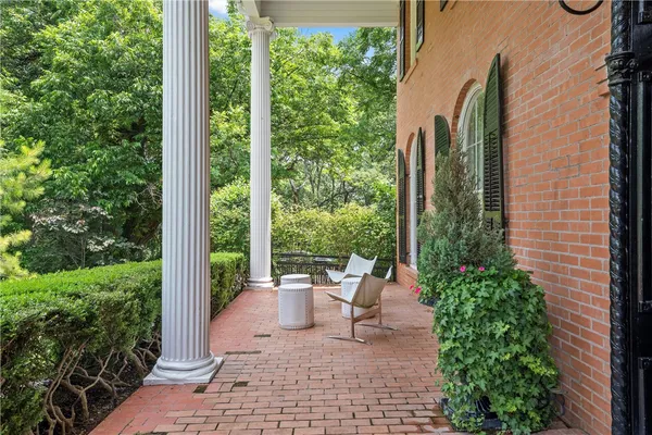 a front view of a house with a garden and parking