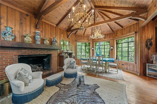 a living room with furniture a chandelier and a window