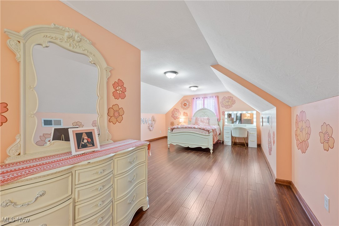 399 Wilder Road Vinton, OH 45686 - Photo 21 of 36 Bedroom with vaulted ceiling and dark wood-style flooring