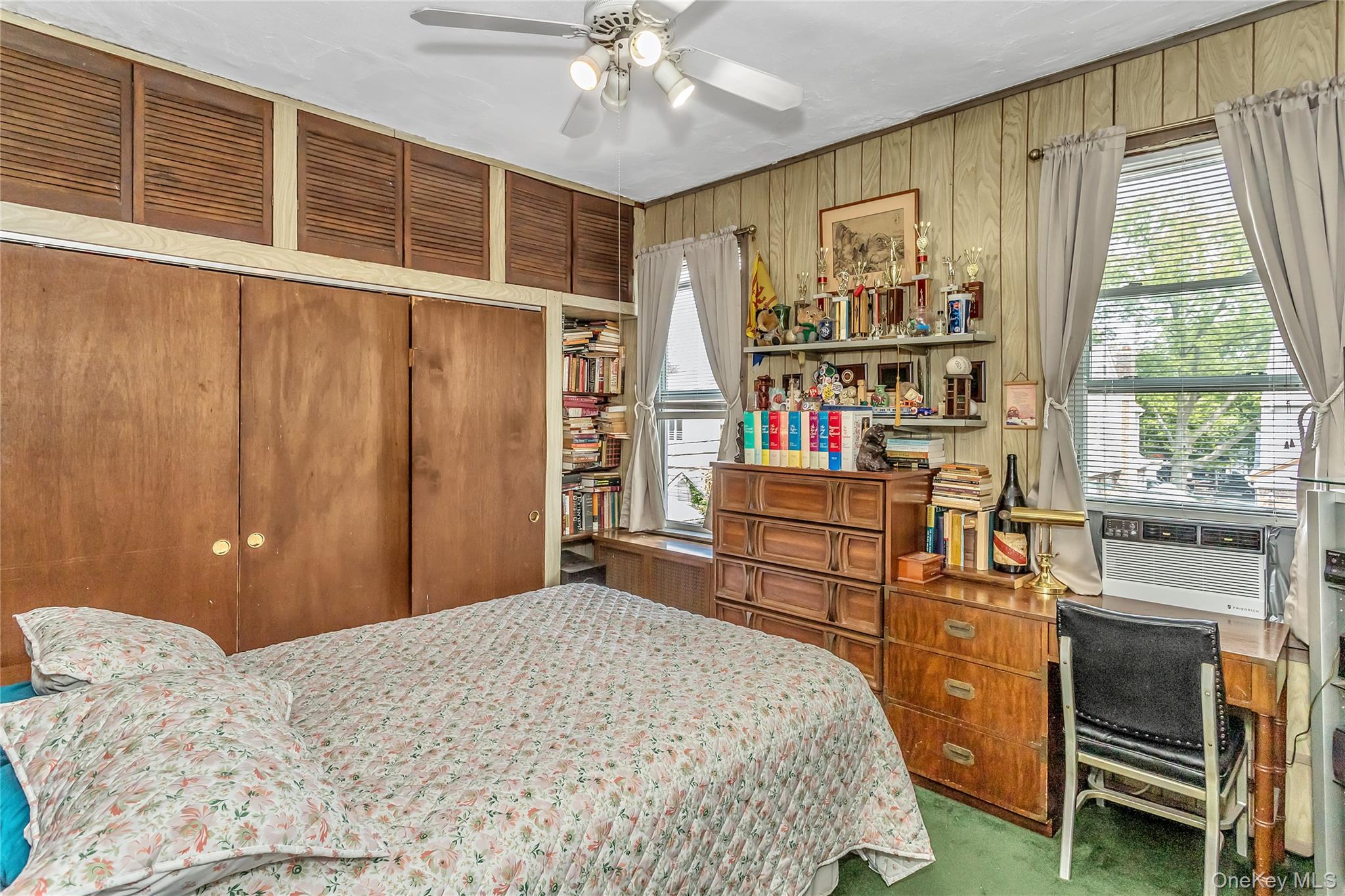 25-41 83rd Street Queens, NY 11370 - Photo 9 of 15 a bedroom with a bed and a window