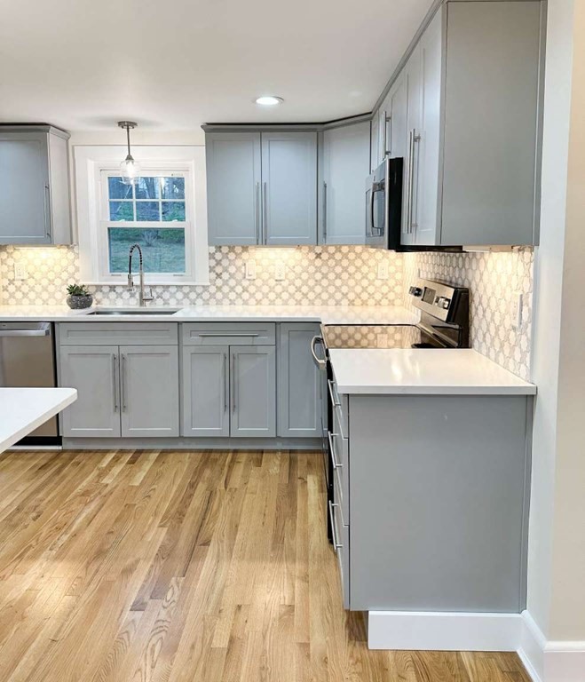 93 Moosehill Road East Walpole, MA 02032 - Photo 4 of 18 a kitchen with kitchen island granite countertop a sink cabinets and wooden floor