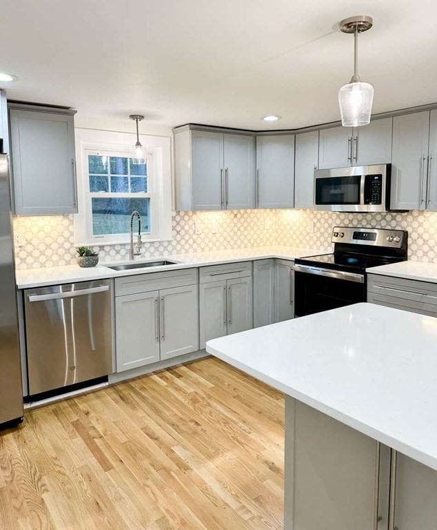 93 Moosehill Road East Walpole, MA 02032 - Photo 5 of 18 a kitchen with stainless steel appliances a sink and a stove
