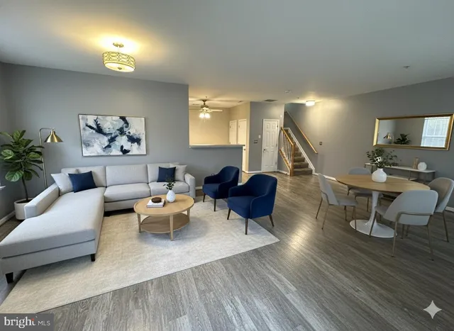 a living room with furniture and wooden floor