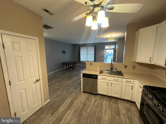a kitchen with a stove a sink and cabinets