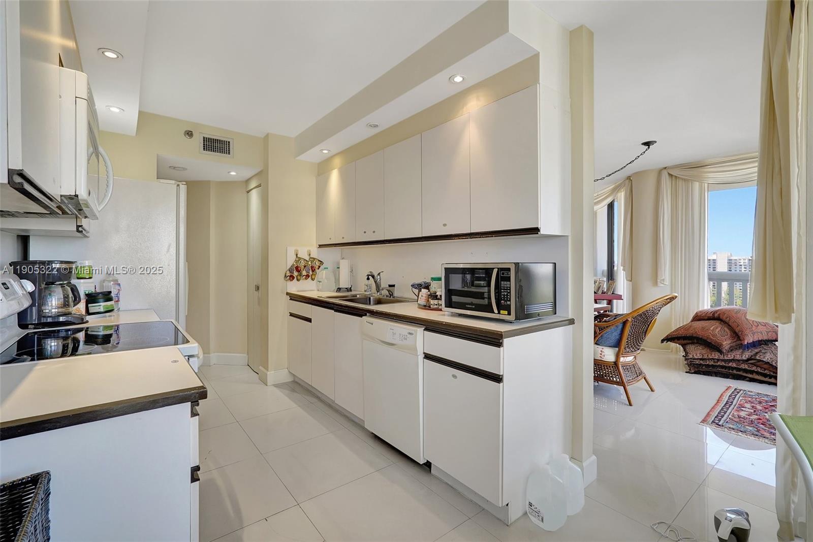 1000 East Island Boulevard, Unit 2004 Aventura, FL 33160 - Photo 12 of 45 a kitchen with a sink appliances and cabinets