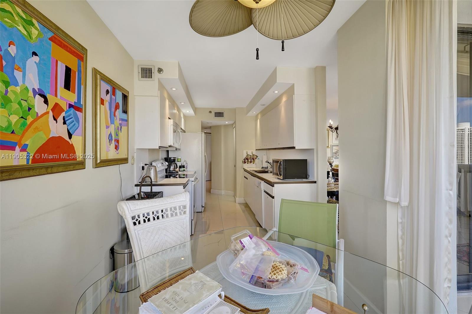 1000 East Island Boulevard, Unit 2004 Aventura, FL 33160 - Photo 20 of 45 a kitchen with stainless steel appliances a stove a chimney a sink and cabinets