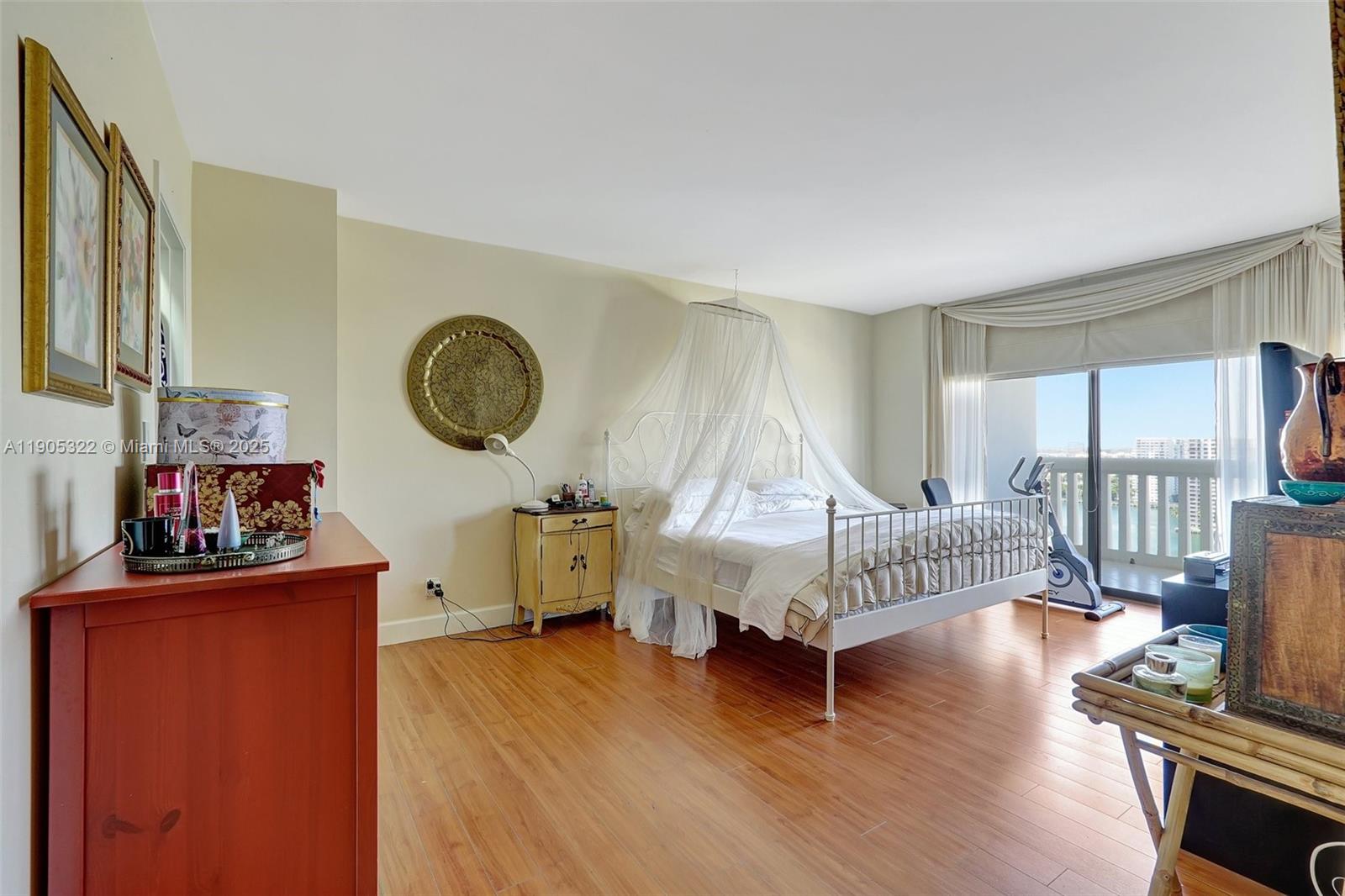 1000 East Island Boulevard, Unit 2004 Aventura, FL 33160 - Photo 22 of 45 a bedroom with furniture and a wooden floor