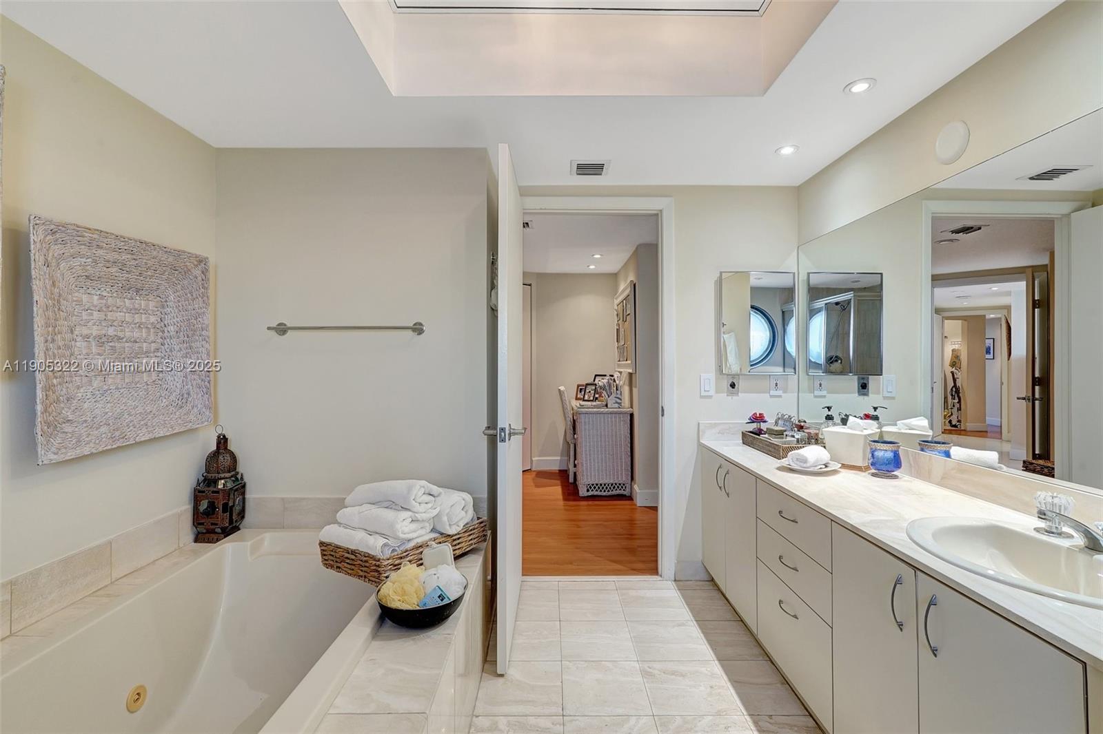 1000 East Island Boulevard, Unit 2004 Aventura, FL 33160 - Photo 23 of 45 a bathroom with a tub sink and mirror