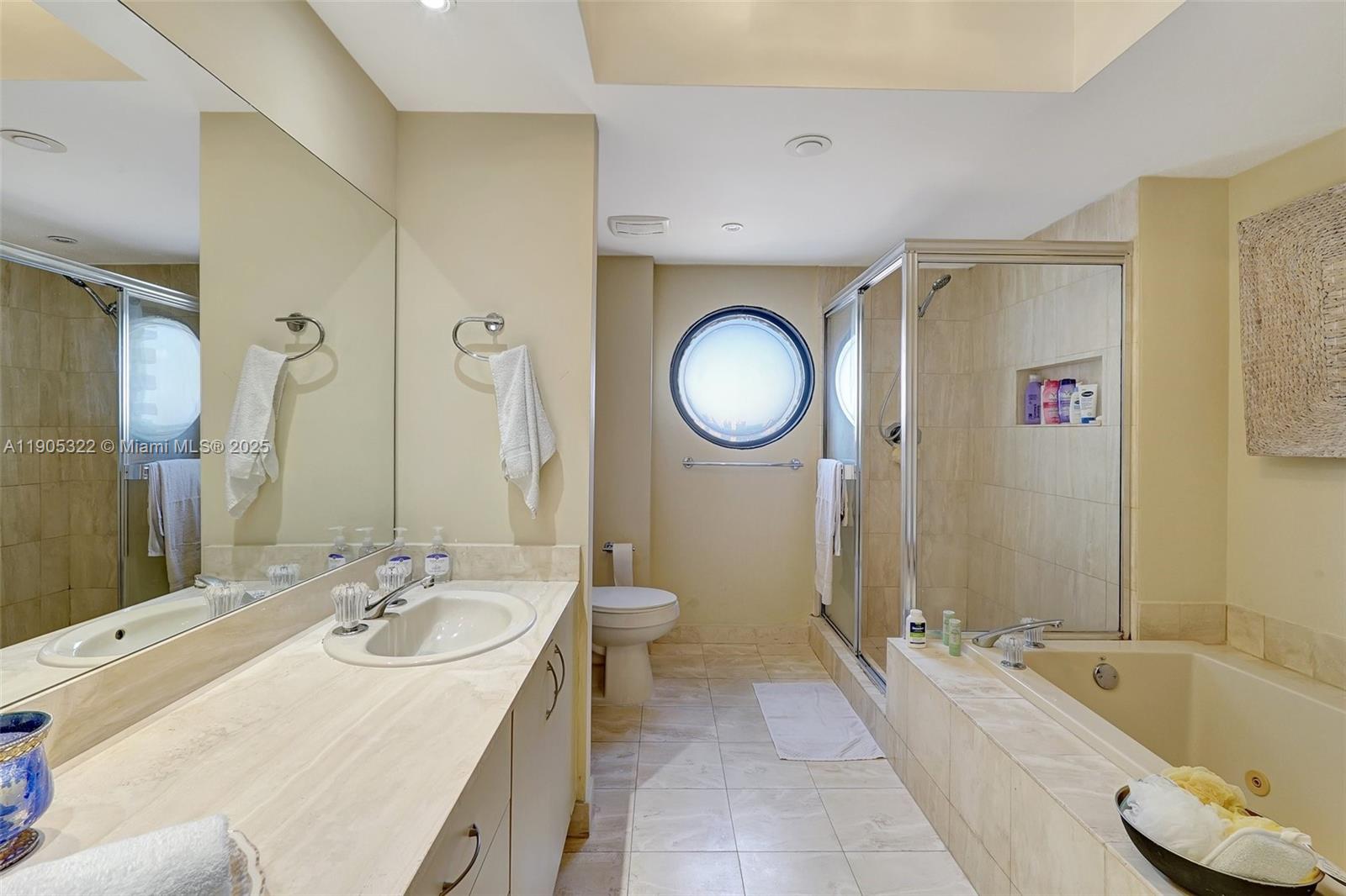 1000 East Island Boulevard, Unit 2004 Aventura, FL 33160 - Photo 24 of 45 a bathroom with a tub sink and mirror