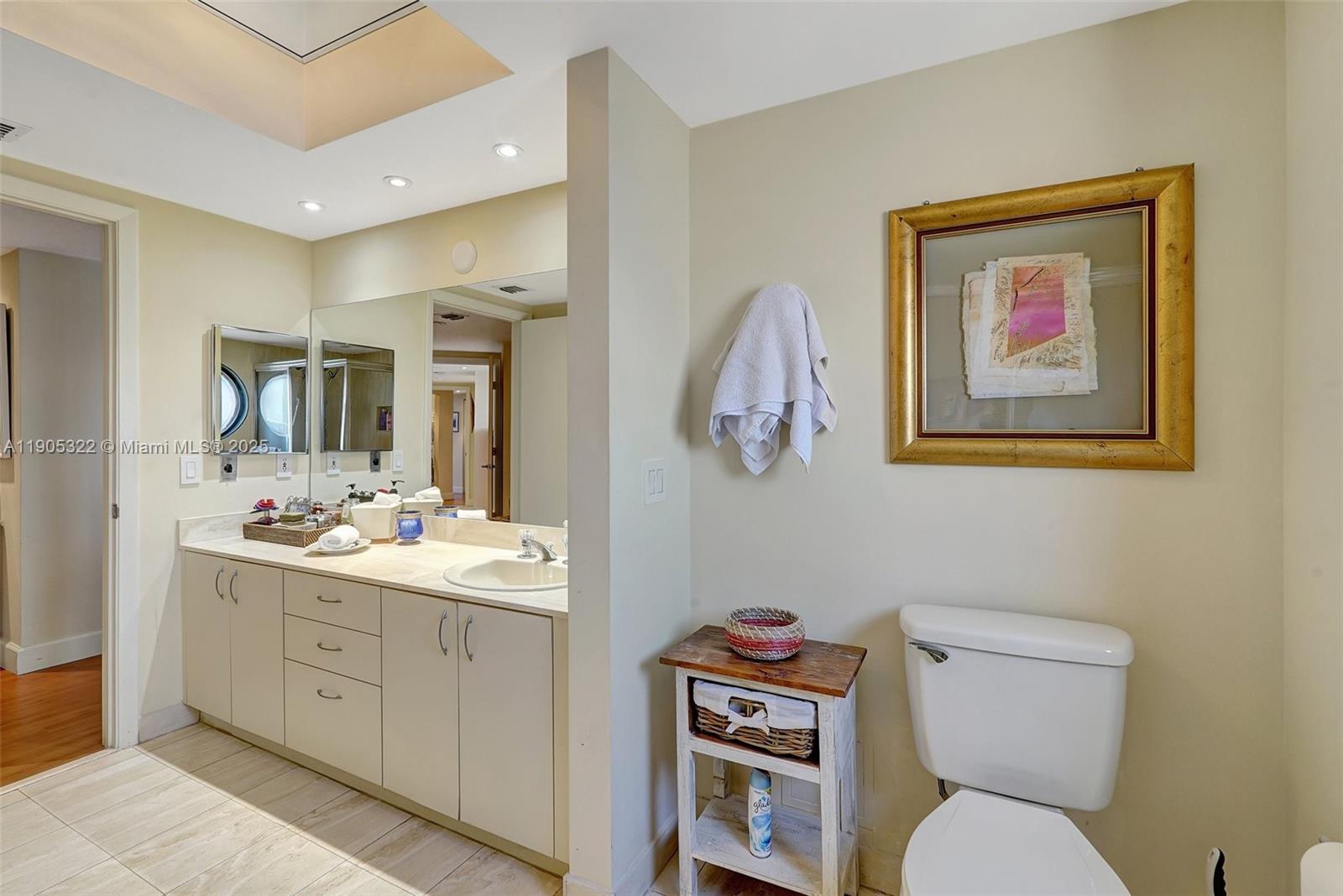 1000 East Island Boulevard, Unit 2004 Aventura, FL 33160 - Photo 27 of 45 a bathroom with a toilet sink and mirror