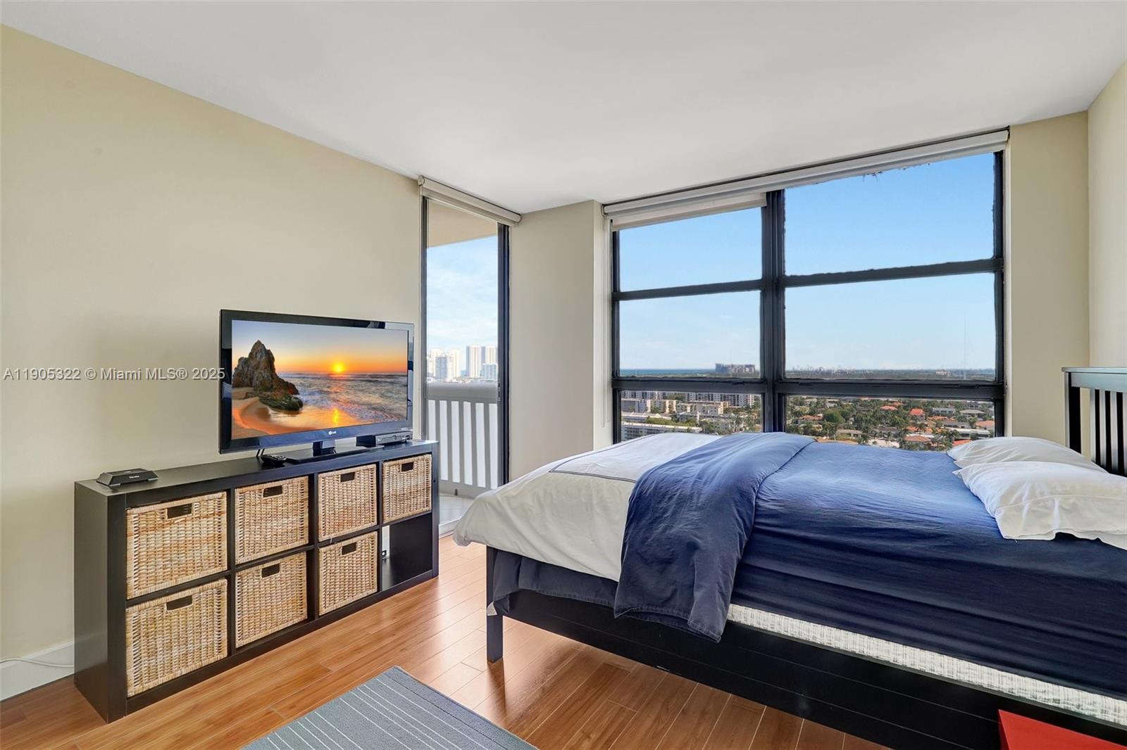 1000 East Island Boulevard, Unit 2004 Aventura, FL 33160 - Photo 29 of 45 a bedroom with a bed window and a flat screen tv